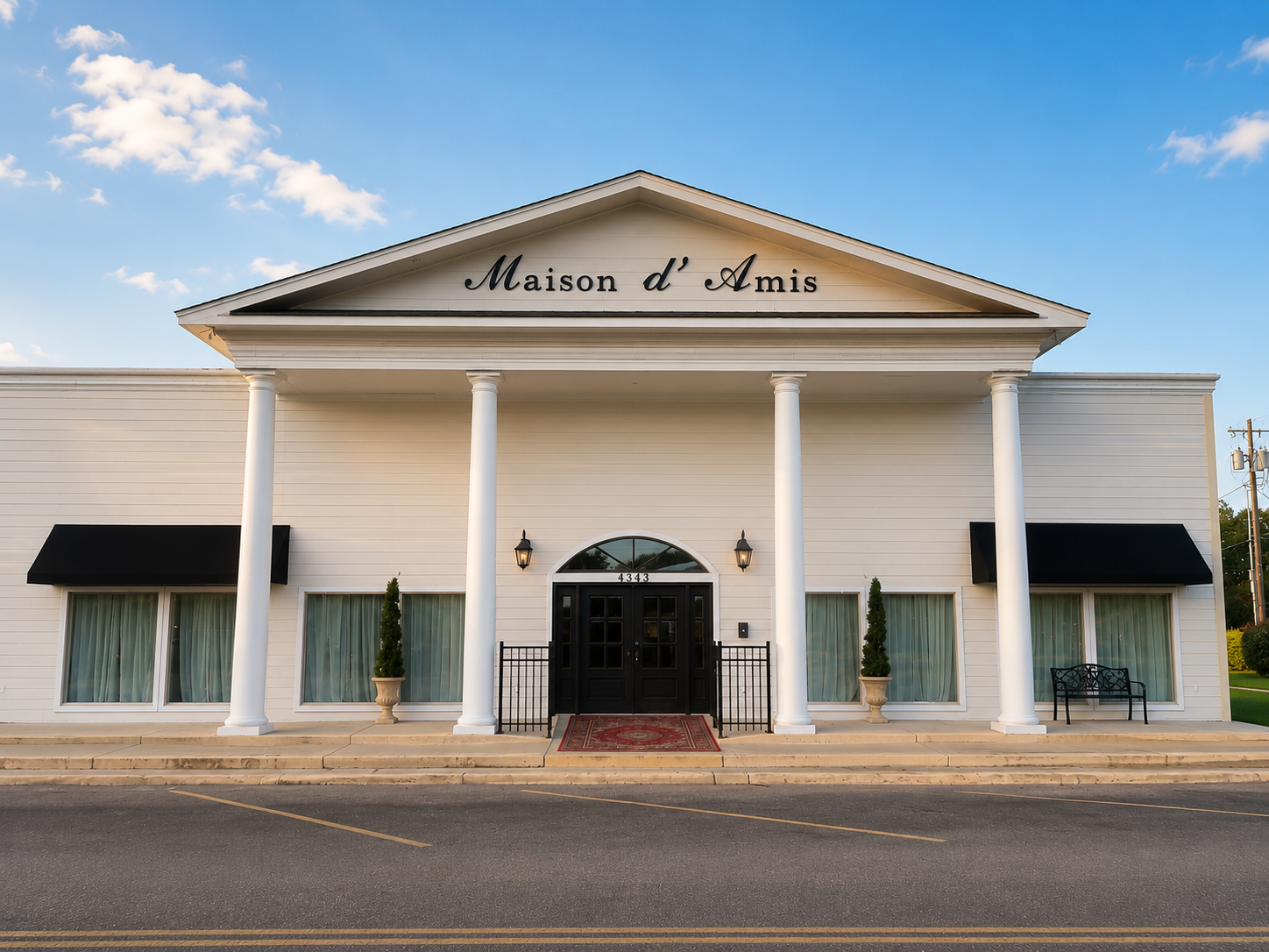 Maison D'Amis white columned entrance in daylight